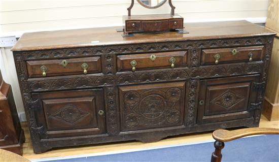 An 18th century oak dresser, with later carved front, W.194cm D.49cm H.88cm